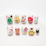 Christmas false nails with candies red gloves and snowman