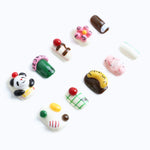 A panda holding a cherry and colorful jellybean press-on nails