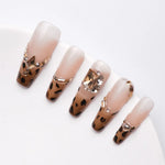 Leopard french tip nails with rhinestones of different sizes