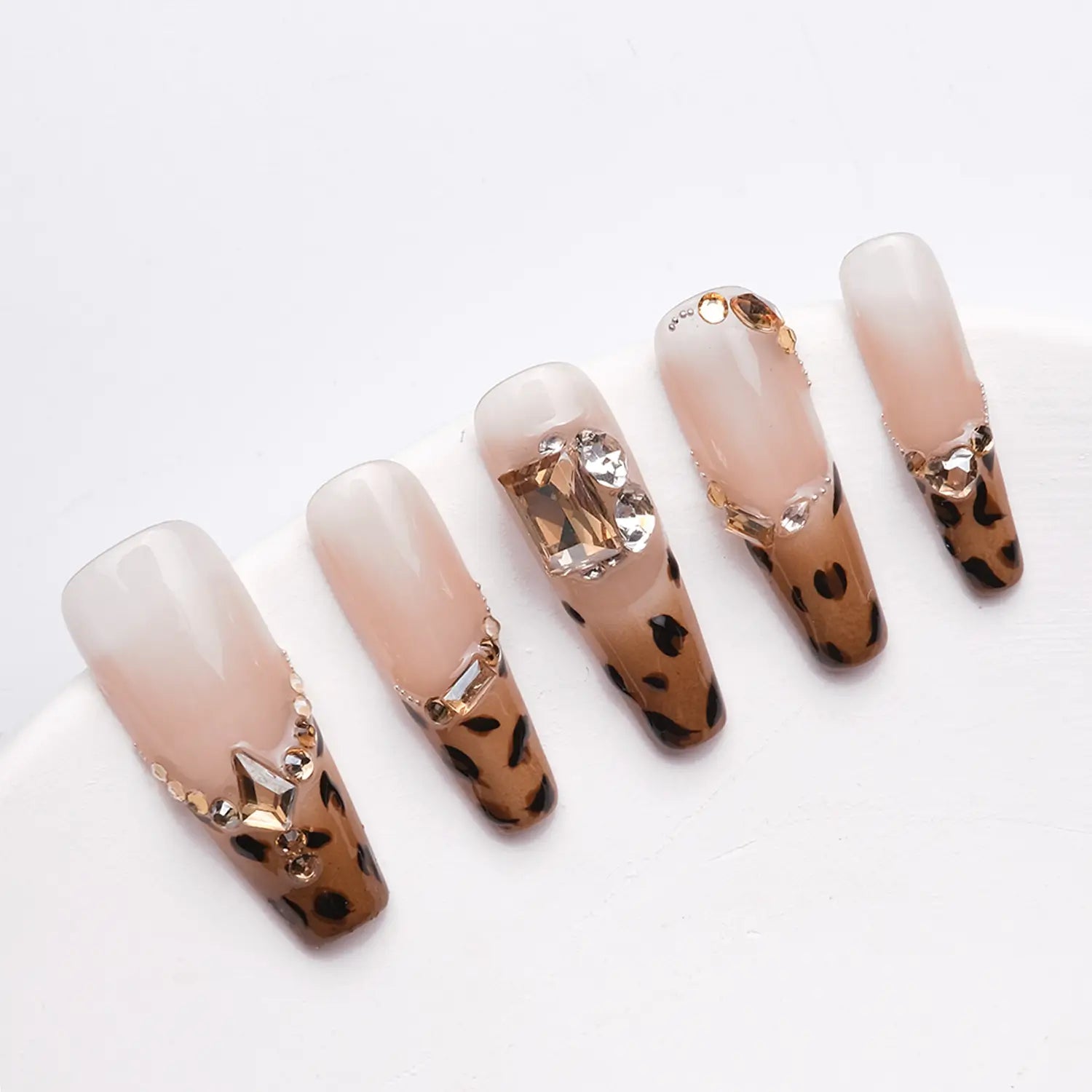 Long coffin french tip nails with rhinestones of different sizes