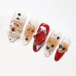 The press-on nails from the side view show light brown and red as the base color, embellished with Christmas trees and diamonds, suitable for gentle girls.
