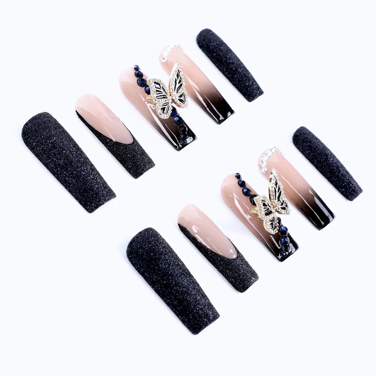 The press-on nails' overall color scheme is a harmonious blend of black and nude tones.