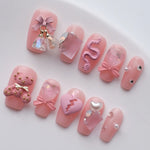 The pink and cute candy nails are matched with sparkling rhinestones, cute bears, sweet bows