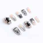 Press-on nails from the right side view, showing the clear nail shape and 3D spider nail design.